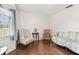 The living room offers bright light with hardwood floors and comfortable striped seating at 1202 Williams Rd, Plant City, FL 33565
