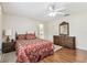 Comfortable bedroom with wood flooring and ensuite bathroom access at 1202 Williams Rd, Plant City, FL 33565