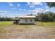 Charming white outbuilding with a red roof, surrounded by a well-maintained lawn at 1202 Williams Rd, Plant City, FL 33565