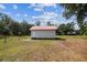Small white outbuilding with a red roof, surrounded by a well-maintained lawn at 1202 Williams Rd, Plant City, FL 33565