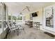 View of the screened-in porch from inside with lots of seating at 1202 Williams Rd, Plant City, FL 33565