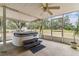 The screened-in porch has a hot tub and fan at 1202 Williams Rd, Plant City, FL 33565