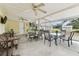 Multiple seating arrangements fill this large screened-in porch at 1202 Williams Rd, Plant City, FL 33565