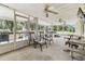 This spacious screened-in porch features multiple seating areas and a television at 1202 Williams Rd, Plant City, FL 33565
