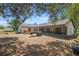 Wide view of a home's backyard featuring a grill and covered porch at 12493 Fish Cove Dr, Spring Hill, FL 34609