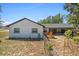 Home's backyard with a small deck and screened in porch at 12493 Fish Cove Dr, Spring Hill, FL 34609