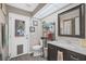 Compact bathroom features a vanity, toilet and a door leading to the outside at 12493 Fish Cove Dr, Spring Hill, FL 34609