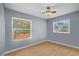 This bedroom features wood floors and lots of natural light at 12493 Fish Cove Dr, Spring Hill, FL 34609