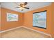 Bright bedroom featuring two large windows, a ceiling fan, and hardwood floors at 12493 Fish Cove Dr, Spring Hill, FL 34609