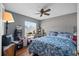 Bedroom featuring a blue floral bedspread and a ceiling fan above at 12493 Fish Cove Dr, Spring Hill, FL 34609