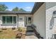 Welcoming front entrance with a charming white door, window, and planters enhancing the home's curb appeal at 12493 Fish Cove Dr, Spring Hill, FL 34609