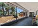 Enclosed patio featuring chairs and a view of the backyard with mature trees at 12493 Fish Cove Dr, Spring Hill, FL 34609