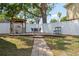 Serene backyard featuring a covered grill, dining area, and privacy fence, perfect for outdoor gatherings at 12606 Rain Forest St, Temple Terrace, FL 33617