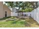 Private backyard featuring a covered grill, dining area, and secure fence, creating an ideal space for entertaining at 12606 Rain Forest St, Temple Terrace, FL 33617