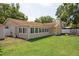 Spacious backyard featuring a sunroom with large windows, a well-maintained lawn, and a covered gazebo at 12606 Rain Forest St, Temple Terrace, FL 33617