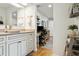 Well-lit bathroom featuring a vessel sink, framed mirrors, decorative accents, and seamless access to a workspace at 12606 Rain Forest St, Temple Terrace, FL 33617
