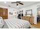 Bright bedroom featuring a ceiling fan, spacious closet, vanity, and a convenient workspace with built-in shelving at 12606 Rain Forest St, Temple Terrace, FL 33617