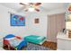 Bedroom with two beds, world map decor, and wood floors at 12606 Rain Forest St, Temple Terrace, FL 33617