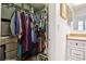Organized walk-in closet with ample storage space, featuring shelves, hanging rods, and easy access to the bathroom at 12606 Rain Forest St, Temple Terrace, FL 33617