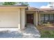 Welcoming entryway with an attractive front door and attached garage at 12606 Rain Forest St, Temple Terrace, FL 33617