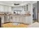 Clean kitchen with stainless steel dishwasher and sink under a bright window at 12606 Rain Forest St, Temple Terrace, FL 33617