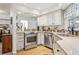 Well-lit kitchen with stainless steel oven and appliances, and wooden floors at 12606 Rain Forest St, Temple Terrace, FL 33617