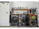 Convenient laundry room with modern washer and dryer, providing storage shelves and essential cleaning supplies at 12606 Rain Forest St, Temple Terrace, FL 33617