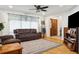Inviting living room with hardwood floors and comfortable leather seating at 12606 Rain Forest St, Temple Terrace, FL 33617