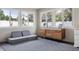 Sunroom features natural light, modular couch, and modern finishes at 12606 Rain Forest St, Temple Terrace, FL 33617