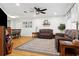 Cozy living room with hardwood floors, ceiling fan, and comfortable leather seating at 12606 Rain Forest St, Temple Terrace, FL 33617