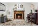 Warm living room with a brick fireplace and piano, creating a welcoming space at 12606 Rain Forest St, Temple Terrace, FL 33617