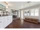 Sunroom features lots of light, dark wood floors, white cabinetry, and access to the outdoors at 12606 Rain Forest St, Temple Terrace, FL 33617