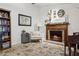 Cozy living room featuring a wood-burning fireplace, decorative rug, and built-in bookcase at 12606 Rain Forest St, Temple Terrace, FL 33617