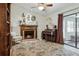 Cozy living room featuring a fireplace, piano, and patterned rug at 12606 Rain Forest St, Temple Terrace, FL 33617