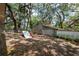 View of the backyard with playset, exterior building and mature trees at 1310 Hilton Pl, Tampa, FL 33604