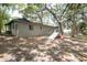 Backyard view with mature trees, play set, and home exterior at 1310 Hilton Pl, Tampa, FL 33604