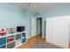 This bedroom features hard wood floors, a grey carpet and blue walls with light coming in from the windows at 1310 Hilton Pl, Tampa, FL 33604