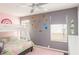 Playful bedroom featuring bunk beds, playful space themed decor, and large windows for natural light at 1310 Hilton Pl, Tampa, FL 33604