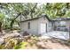 Home exterior featuring a detached garage and a beautiful yard at 1310 Hilton Pl, Tampa, FL 33604