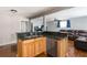 Open kitchen with granite countertop island and view into the living room at 1310 Hilton Pl, Tampa, FL 33604