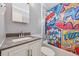 Fun bathroom with comic-style shower curtain, sink and toilet at 1341 Sandy Ln, Clearwater, FL 33755