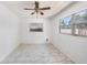 Clean, bright bedroom with a ceiling fan and large window at 1341 Sandy Ln, Clearwater, FL 33755