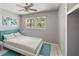 Bright bedroom featuring natural light, neutral decor, and cool blue accents at 1341 Sandy Ln, Clearwater, FL 33755