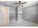 Neat bedroom space with built-in shelf, ceiling fan, and a large window at 1341 Sandy Ln, Clearwater, FL 33755