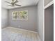 Simply designed bedroom with natural light, a ceiling fan, and neutral paint at 1341 Sandy Ln, Clearwater, FL 33755