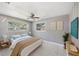 Comfortable bedroom with natural light, neutral decor, and sleek ceiling fan at 1341 Sandy Ln, Clearwater, FL 33755