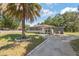 Charming single-story home with a well-maintained lawn, mature landscaping, and inviting curb appeal at 1341 Sandy Ln, Clearwater, FL 33755