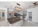 Modern kitchen with granite countertops, gray cabinets, stainless steel appliances, and an island with seating at 1341 Sandy Ln, Clearwater, FL 33755