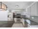 Well-equipped kitchen with stainless steel appliances, granite countertops, and stylish gray cabinetry at 1341 Sandy Ln, Clearwater, FL 33755