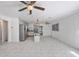 An open-concept layout integrates a kitchen island with seating, all highlighted by sleek marble flooring at 1341 Sandy Ln, Clearwater, FL 33755